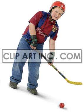 A young boy wearing a red helmet and sports attire is holding a hockey stick and is about to hit a red ball.