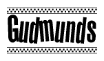 The image contains the text Gudmunds in a bold, stylized font, with a checkered flag pattern bordering the top and bottom of the text.