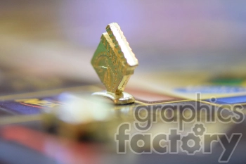 Close-up image of a gold game piece on a board game.