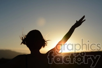 sunset with female arms raised