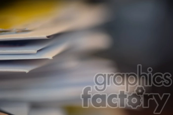 Blurred close-up of a stack of papers, focusing on the edges of the documents.
