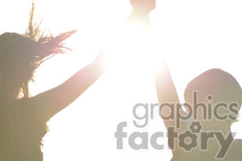 A high-key image of two people holding hands with raised arms. The bright light obscures most of the details.