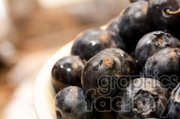 Close-up of fresh, ripe blueberries with water droplets on them.