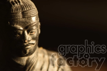 Close-up view of an ancient Chinese warrior statue, possibly a terracotta soldier, with intricate facial details.