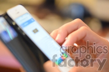 Close-up view of a hand holding a smartphone. The screen displays a website with text and colorful icons at the bottom.