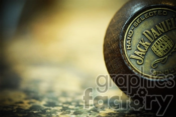 Close-up of a 'Jack Daniel's' branding seal on a wooden circular surface, emphasizing 'Hand-Selected' and a barrel design.