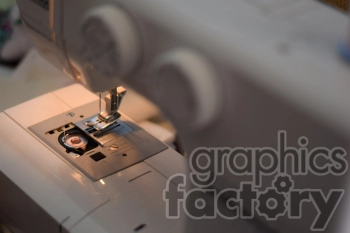 Close-up view of a sewing machine, focusing on the needle and stitch selection area.