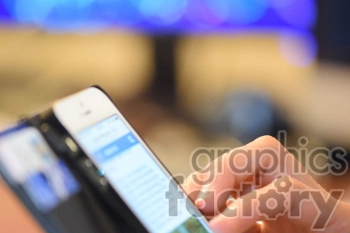 A close-up image of a person using a smartphone, with their fingers interacting with the touchscreen. The background is blurred, focusing on the hand and the phone screen.