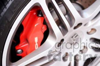 Close-up view of a Porsche sports car wheel and red brake caliper.
