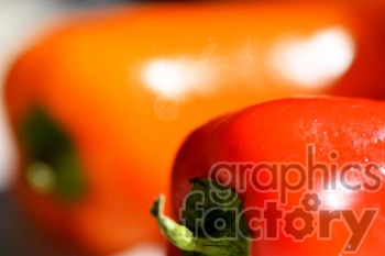 Close-up of red and orange bell peppers with a blurred background.