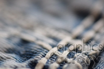 Close-up view of a woven textile fabric with interlacing threads in blue and white.