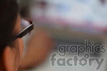 Close-Up of Person with Glasses Using a Laptop