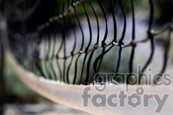 Close-up of a black netting with blurred background, focusing on the texture and weave of the net.