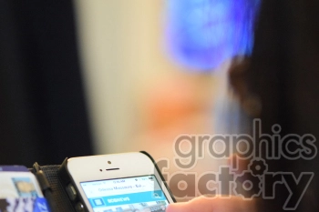 A close-up of a person using a smartphone. The person is browsing a news website with the headline 'Odessa Massacre - Evidence'. The smartphone is held in a black phone case, and there are blurred background elements.