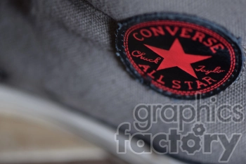 A close-up image of a Converse All Star shoe label, featuring a red star emblem and the text 'Chuck Taylor'.