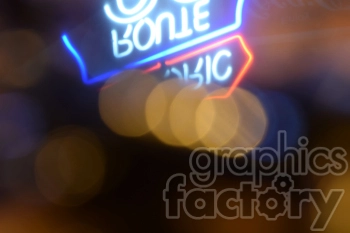 A blurred image of neon signs with bokeh effects in the background. The neon signs display blue and red colors creating a vibrant, abstract visual.