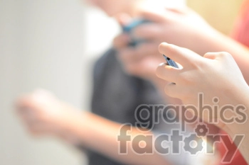 A close-up view of people using smartphones, focusing on hands holding the devices.